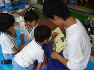 幼稚園児が、中学生に絵本を読んでもらっています